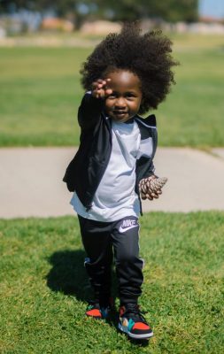 taylor-smith-m6F81ANQzvo-unsplash AA boy in sweatsuit with pinecone